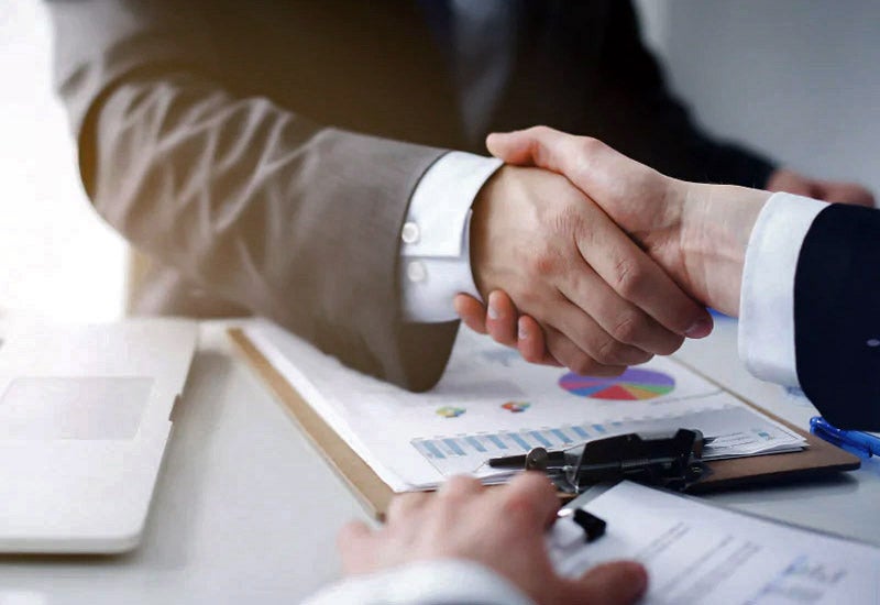 Professional handshake over car finance papers